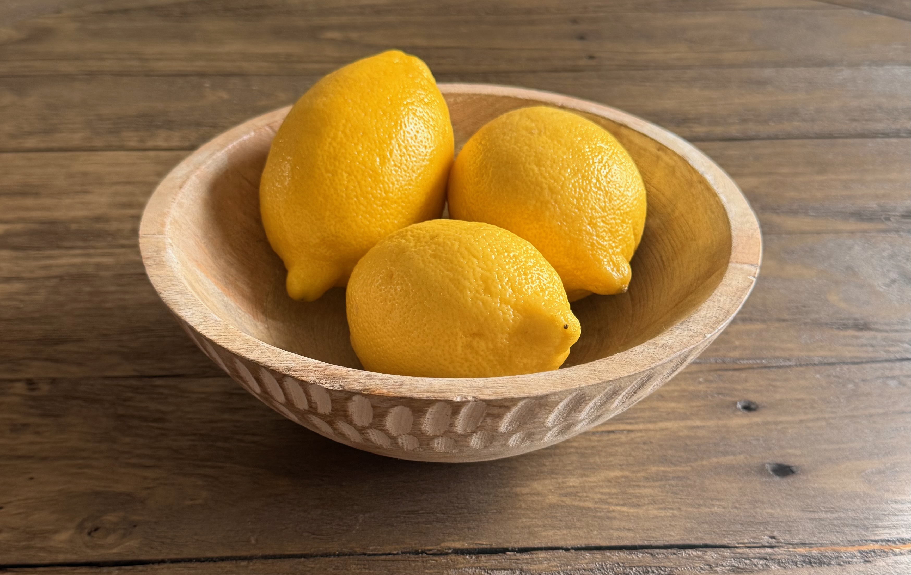 Carved mango wood bowl with lemons