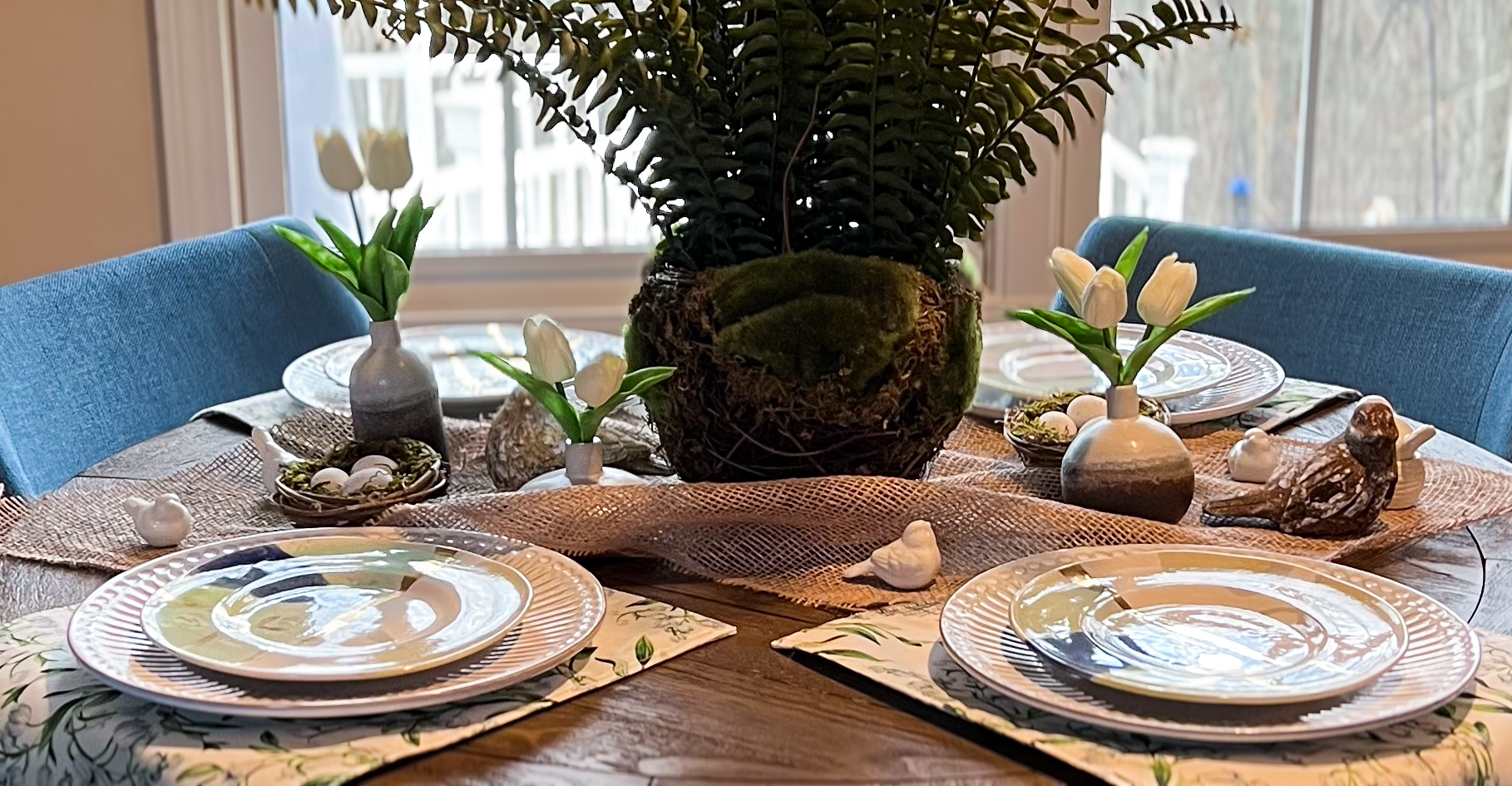 Spring fern tablescape with white tulips and ceramic birds